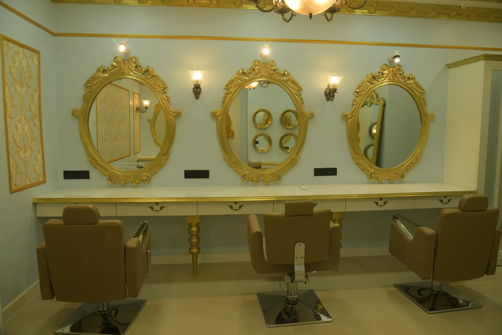 Le Beau styling stations with ornate gold mirrors